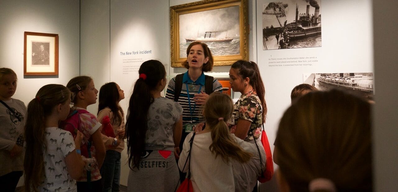 Group of school kids with teacher in Titanc exhibit