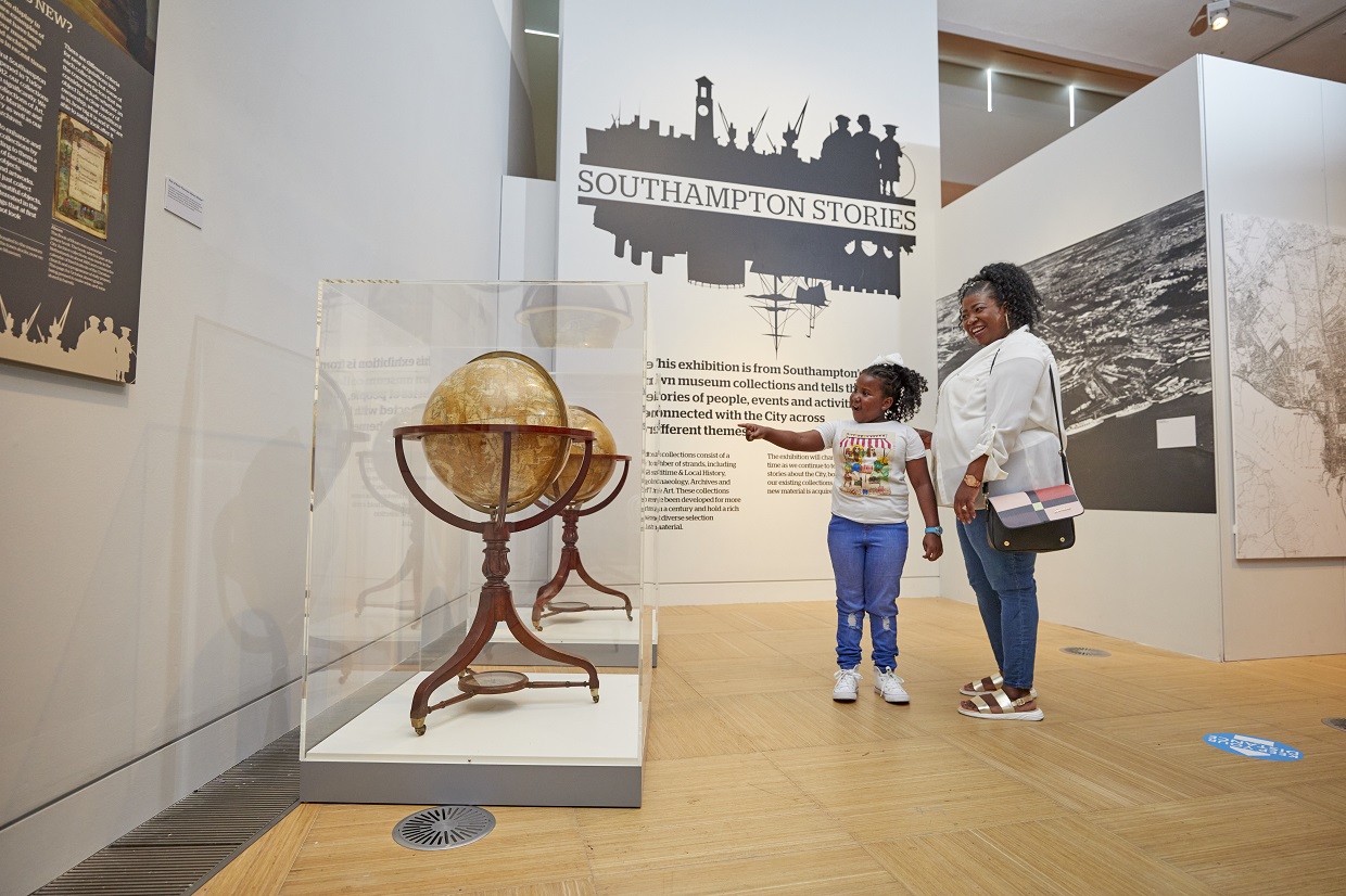 Family looking at globes in museum